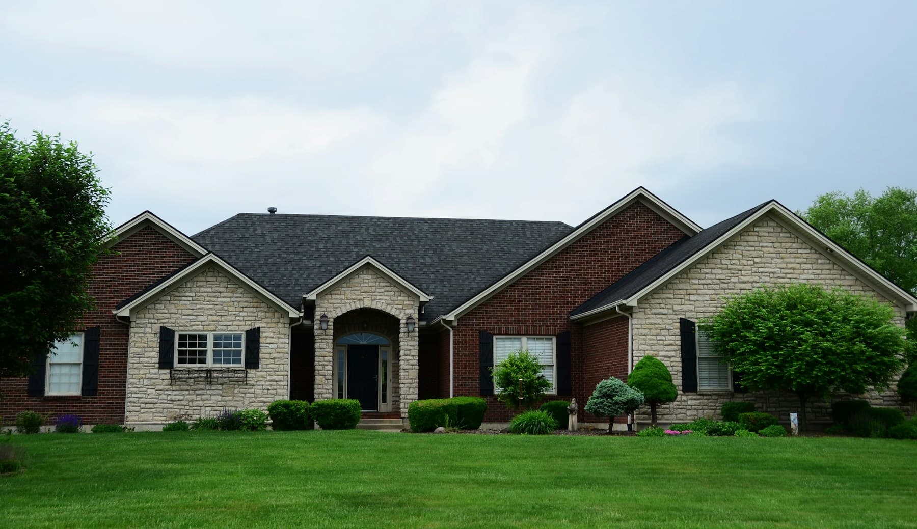 A welcoming home with a green front lawn